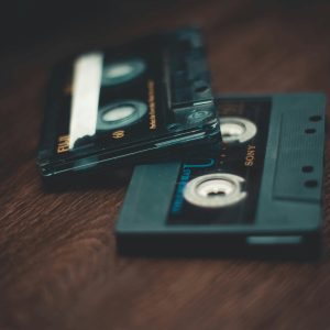 Close Up Of Retro Cassette Tapes On A Wooden Table With Depth Of Field Effect.