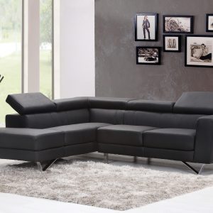 Contemporary Living Room Featuring A Sleek Black Sectional Sofa And Chic Wall Art.