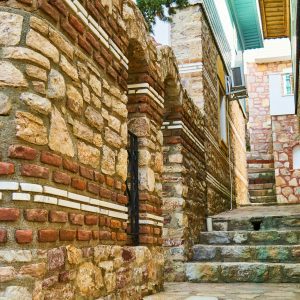 Traditional Stone And Brick Alleyway Showcasing Vintage Architecture.
