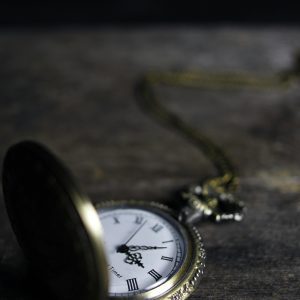 Close Up Of An Ornate Vintage Pocket Watch On A Wooden Surface, Exemplifying Timeless Elegance.