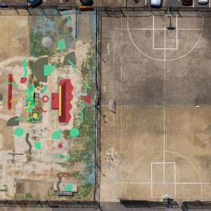 Drone View Of An Outdoor Basketball Court And Vibrant Skate Park In An Urban Setting.