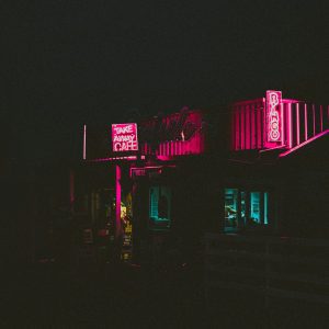 A Retro Diner Illuminated By Neon Lights At Night, Creating A Vibrant Glow.