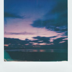 Capture The Beauty Of A Vibrant Sunset Over A Tranquil Lake In This Vintage Polaroid Photo.
