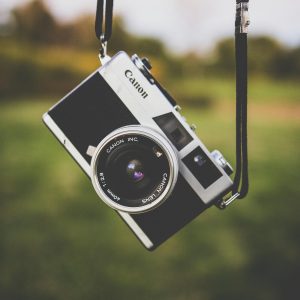 Classic Film Camera Suspended Outdoors, Capturing Retro Vibes.