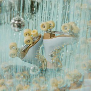 Retro Roller Skates In A Sparkling Disco Setting With Hanging Glitter And Lights.
