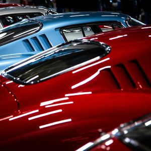 A Striking Lineup Of Vintage Cars Showcasing Sleek Design And Vibrant Colors.