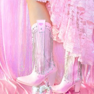 Pink Cowboy Boots With Fringes And A Disco Ball On A Pastel Pink Backdrop.