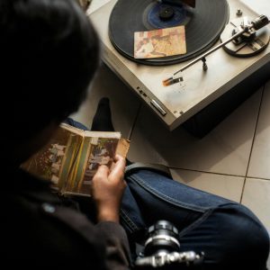 A Nostalgic Moment Of Enjoying Vintage Records On A Turntable With Old Photographs.