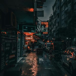 Dark Urban Street At Night With Glowing Neon Lights Reflecting On Wet Pavement.