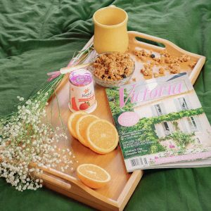 A Cozy Breakfast With Granola, Yogurt, And A Magazine On A Wooden Tray.