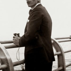 A Vintage Black And White Photo Of A Man Holding Binoculars On A Pier, Evoking Nostalgia.