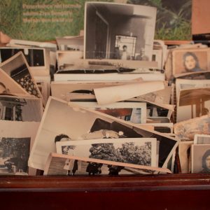 A Collection Of Old Black And White Photographs Stored In A Vintage Wooden Box, Evoking Nostalgia.