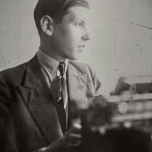 A Vintage Black And White Portrait Of A Young Man In A Suit Looking Away.
