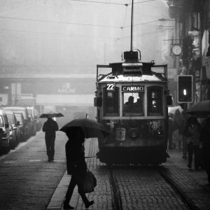 A Black And White Photo Of A Tram In Porto, Capturing Rainy Street Life And Public Transportation.