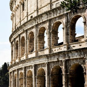 Detailed Shot Of The Iconic Colosseum Exterior In Rome, Highlighting Its Ancient Architecture.