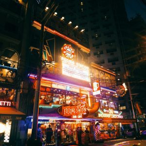 Colorful Neon Lights Illuminate A Retro Diner Scene At Night.