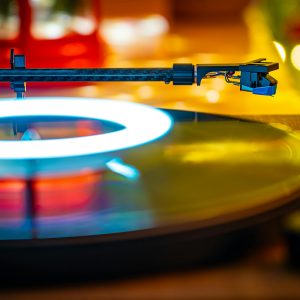 Colorful Bokeh Turntable Playing Vinyl Under LED Lights Indoors. Cozy And Retro Vibes.