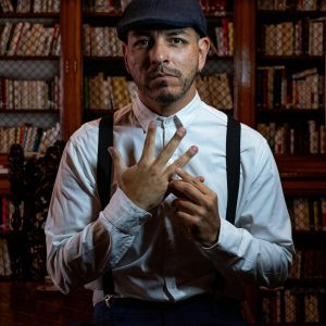 Man Wearing Vintage Attire In A Classic Buenos Aires Library, Captured Indoors.