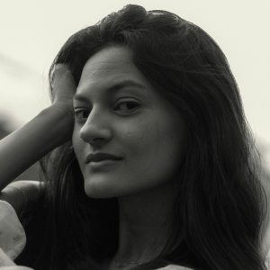 Stunning Black And White Portrait Of A Young Woman Showcasing Elegance.