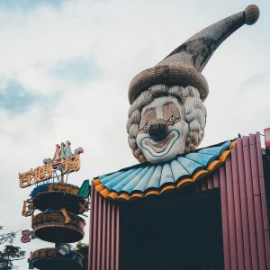 A Vintage Clown Head Decorates The Entrance Of An Amusement Park, Creating A Nostalgic Atmosphere.