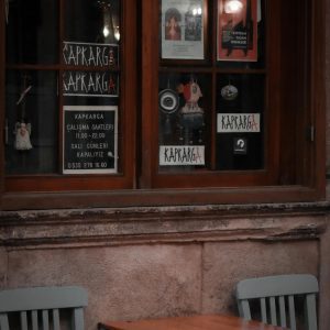 Charming Daytime View Of A Street Cafe With Vintage Decor And Empty Seating.
