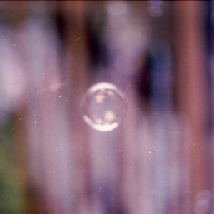 Ethereal Film Photograph Capturing A Single Bubble Surrounded By A Dreamy Blur.