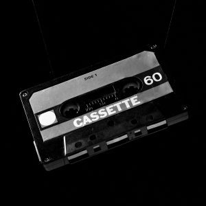 Classic Cassette Tape On A Black Background, Capturing Retro Audio Nostalgia.