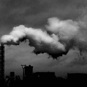 Black And White Image Of Factory Emissions Illustrating Industrial Pollution.