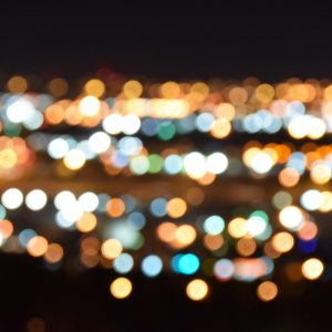 A Mesmerizing View Of Blurred City Lights Creating A Colorful Bokeh Effect At Night.