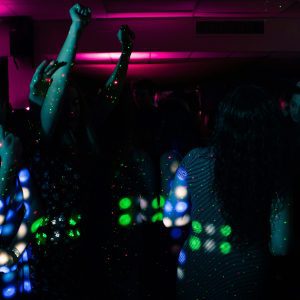 Energetic Nightclub Scene With People Dancing Under Colorful Neon Lights. Perfect For Nightlife Themes.