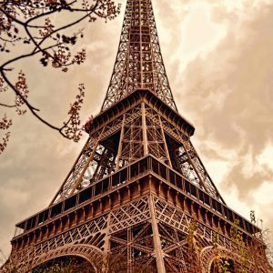 Low Angle View Of The Eiffel Tower Against A Dramatic Sepia Toned Sky In Paris.