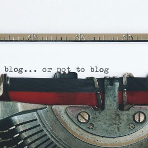 Classic Typewriter With 'to Blog Or Not To Blog' Typed On Paper.