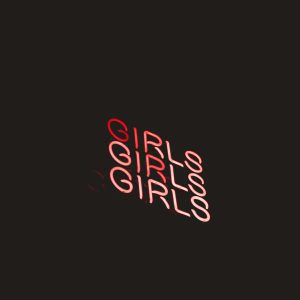 Vibrant Neon Sign Displaying The Word 'Girls' In Red Against A Dark Background.