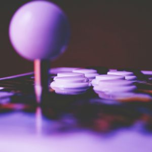 A Vibrant Close Up Image Of An Arcade Joystick And Buttons, Capturing A Retro Gaming Mood.
