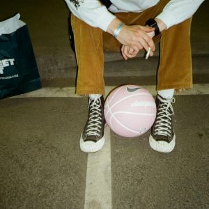 Man With A Pink Basketball Sitting In A Moscow Parking Lot.