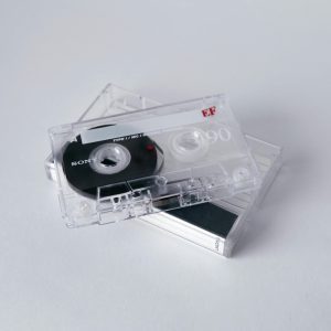 Vintage Cassette Tapes Stacked On A White Background, Evoking Nostalgia And Classic Music Vibes.