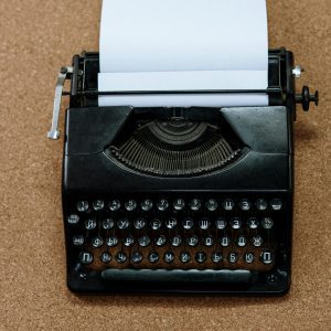 Classic Black Typewriter With Cyrillic Keys On A Cork Board For A Retro Aesthetic.