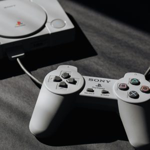 Retro Sony PlayStation Console With Classic Controller, Evoking Nostalgic Gaming Memories.