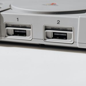 Detailed View Of Vintage PlayStation Console Featuring Memory Slots, Capturing Nostalgia.