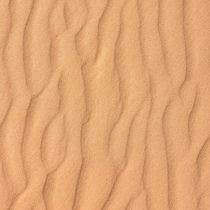 Close Up Of Textured Sand Dunes, Capturing Natural Patterns And Ripples. Perfect For Nature And Texture Themes.