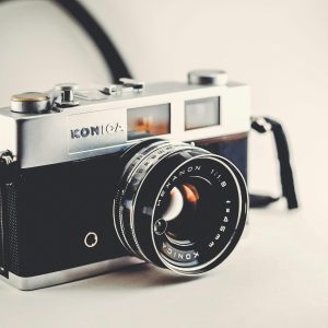 Vintage Konica Camera With A Sleek, Classic Design And Lens Details.
