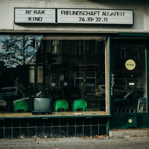 A Vintage Storefront Displaying An Old TV, Books, And Posters, Reflecting A Nostalgic Urban Atmosphere.