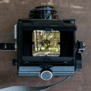 A Top View Of A Vintage Camera Displaying An Outdoor Scene Through The Viewfinder.