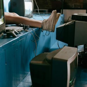 A Nostalgic Indoor Scene Of Vintage Video Game Consoles And TV Screens With A Focus On Retro Aesthetics.