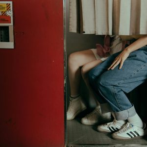 A Romantic Couple Captured In A Vintage Photobooth, Highlighting A Nostalgic And Intimate Moment Together.