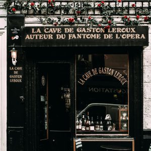 A Quaint Vintage Cafe With Classic Decor And Vibrant Floral Accents On A Paris Street.