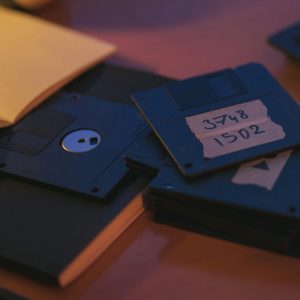 Retro Floppy Disks On A Desk Evoke Nostalgia And Early Digital Storage History.