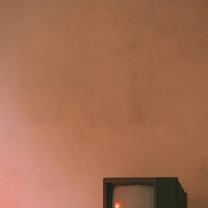 An Old CRT TV In A Minimalist Room With Warm Lighting And Vintage Style.