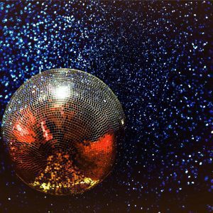 Shining Disco Ball With Colorful Reflections In A Dark, Starry Background.