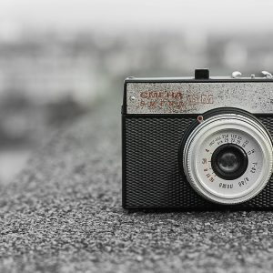 Classic Vintage Camera Resting On A Rough Concrete Surface, Showcasing Soviet Design.